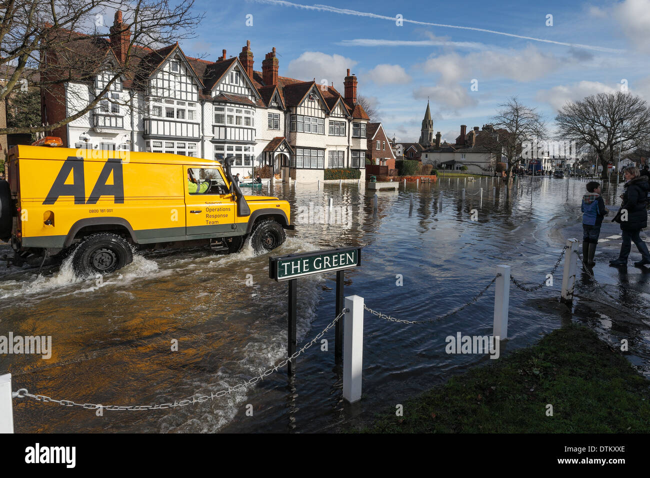 An AA vehicle drives through a flooded road in the centre of Datchet after the River Thames burst its banks Stock Photo
