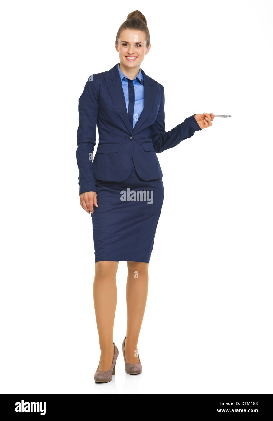 Full length portrait of business woman pointing on copy space with pen Stock Photo
