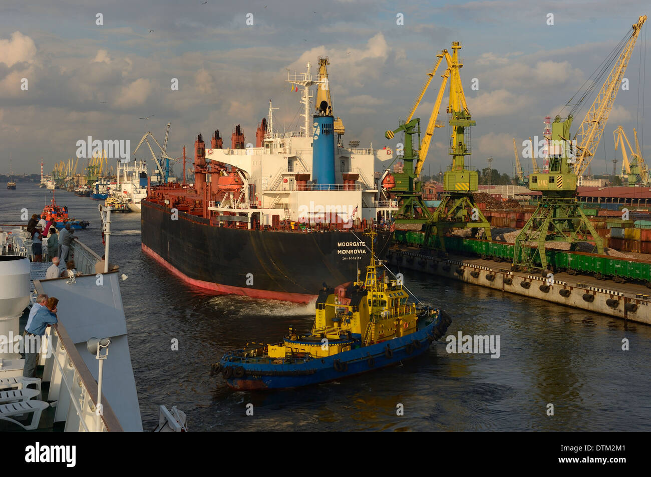 A cruise ship passing St Petersburg industrial docks. Russia Stock