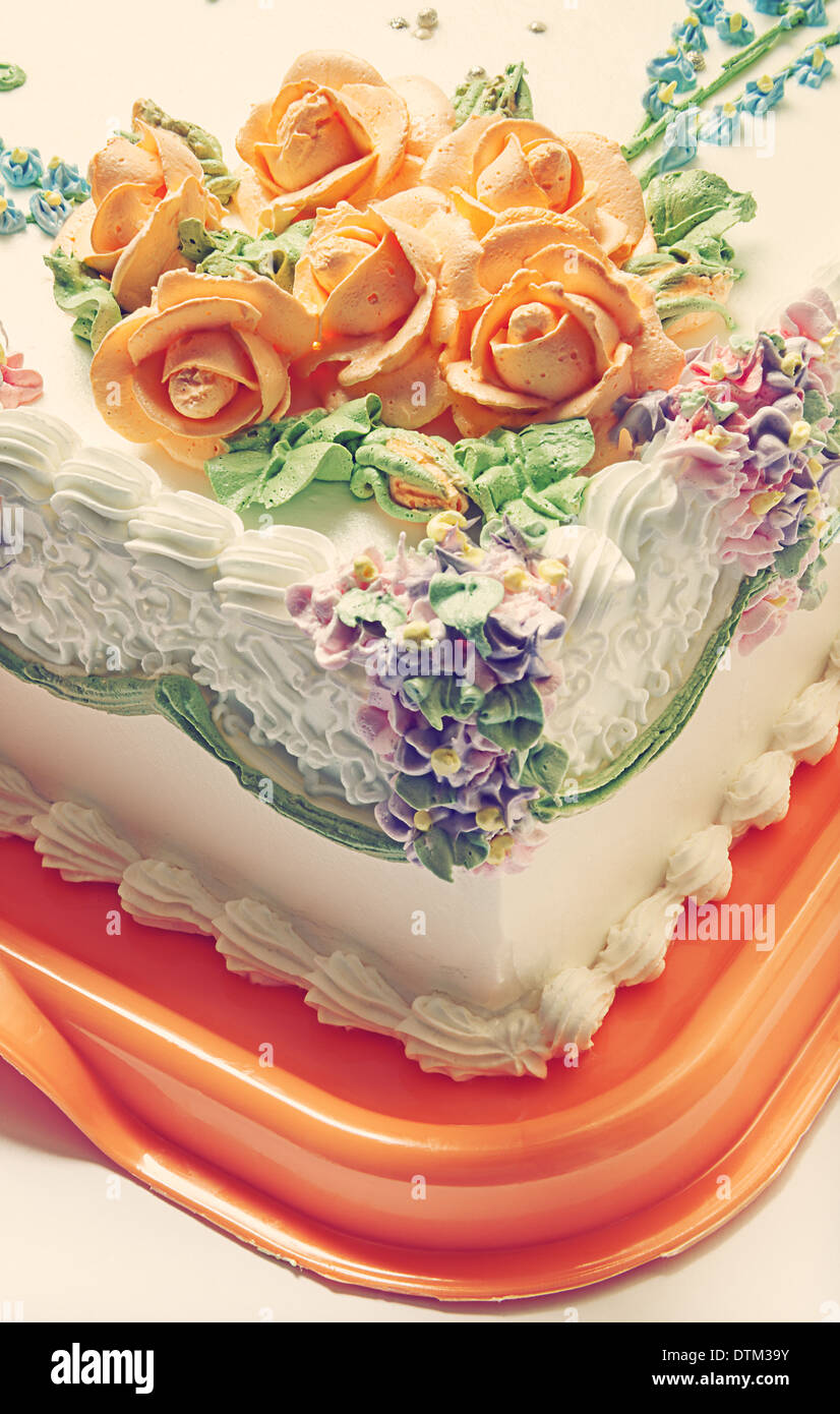 Classical birthday cake design with a lot of flowers of cream Stock Photo -  Alamy
