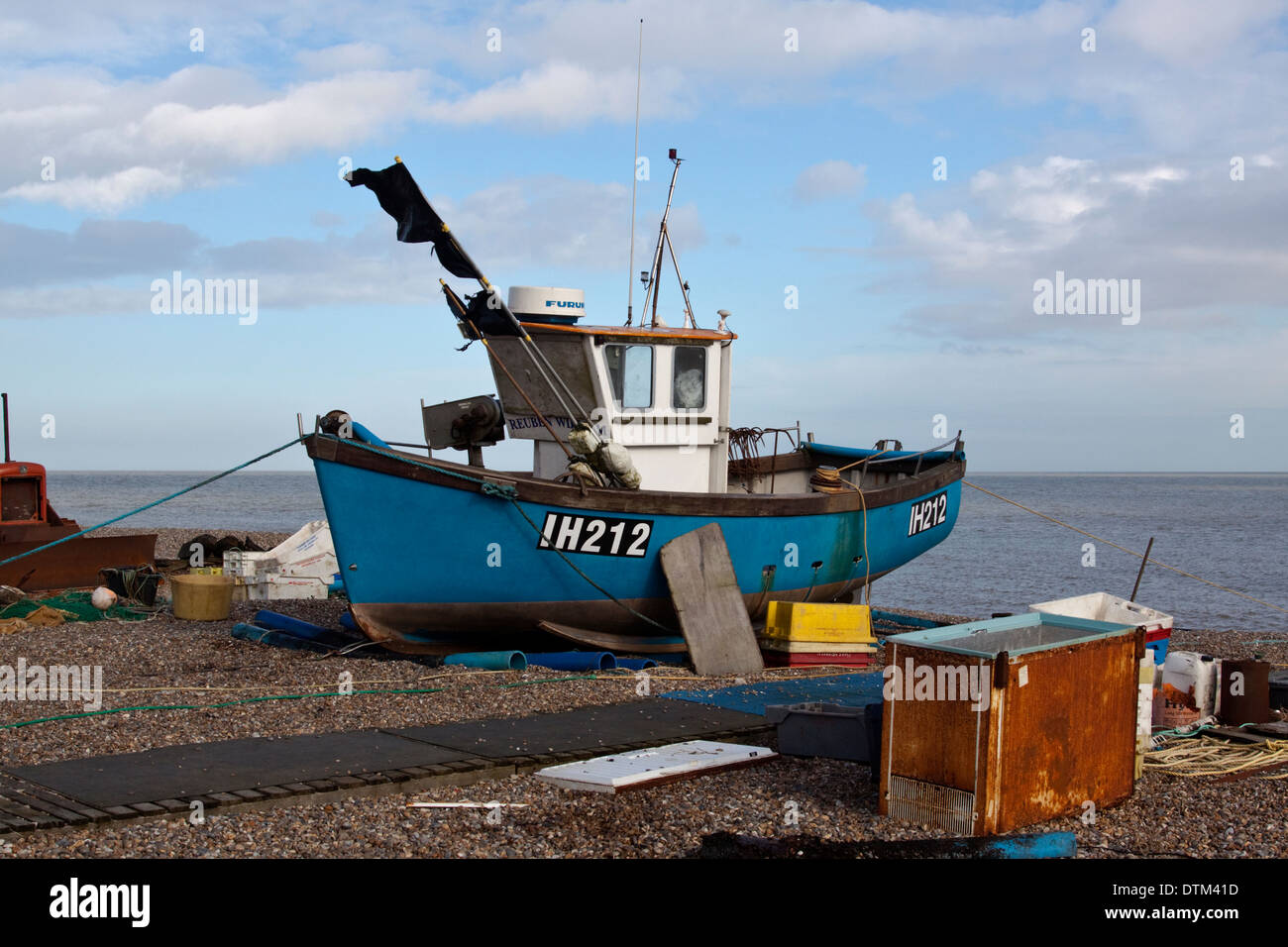 Aldeburgh fishing boat IH212 Reuben William on the beach and surrounded by fishing paraphenalia Stock Photo