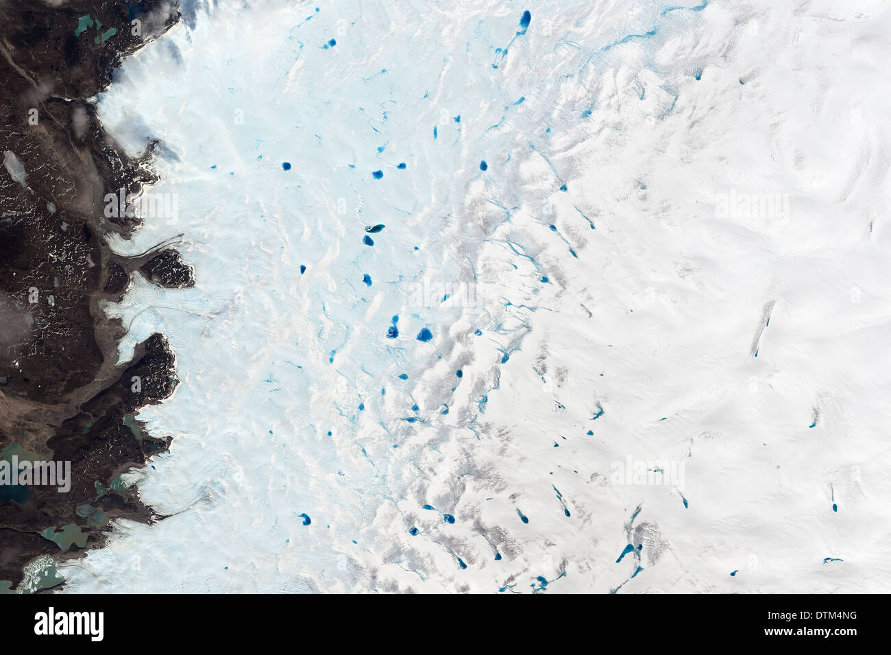 pools of blue meltwater on Greenlands ice show in springtime as seen in NASA's Landsat 8 image from space. Stock Photo