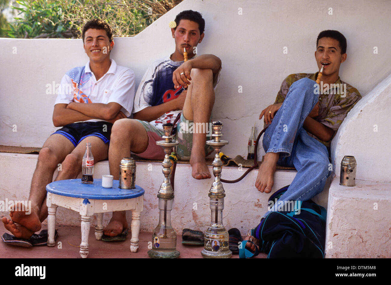 Tunisia, Sidi Bou Said. Young Tunisian Men Smoking a Sheesha at the Cafe Sidi Sha'ban. Stock Photo