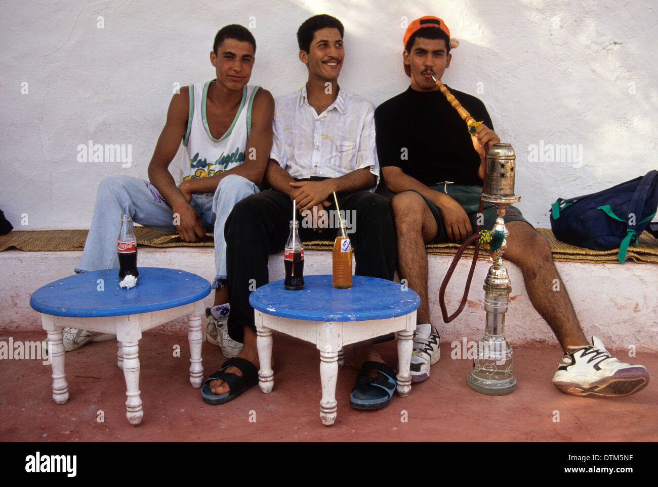 Tunisia, Sidi Bou Said. Young Tunisian Men Smoking a Sheesha at the Cafe Sidi Sha'ban. Stock Photo