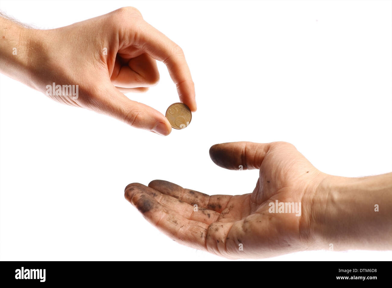A clean hand offering a coin to a dirty hand. Stock Photo