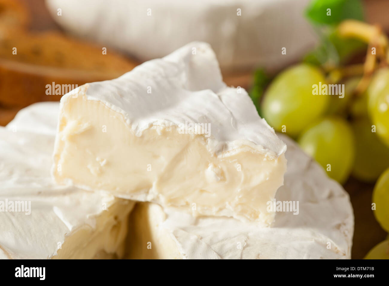 Organic Homemade White Brie Cheese with Bread and Grapes Stock Photo