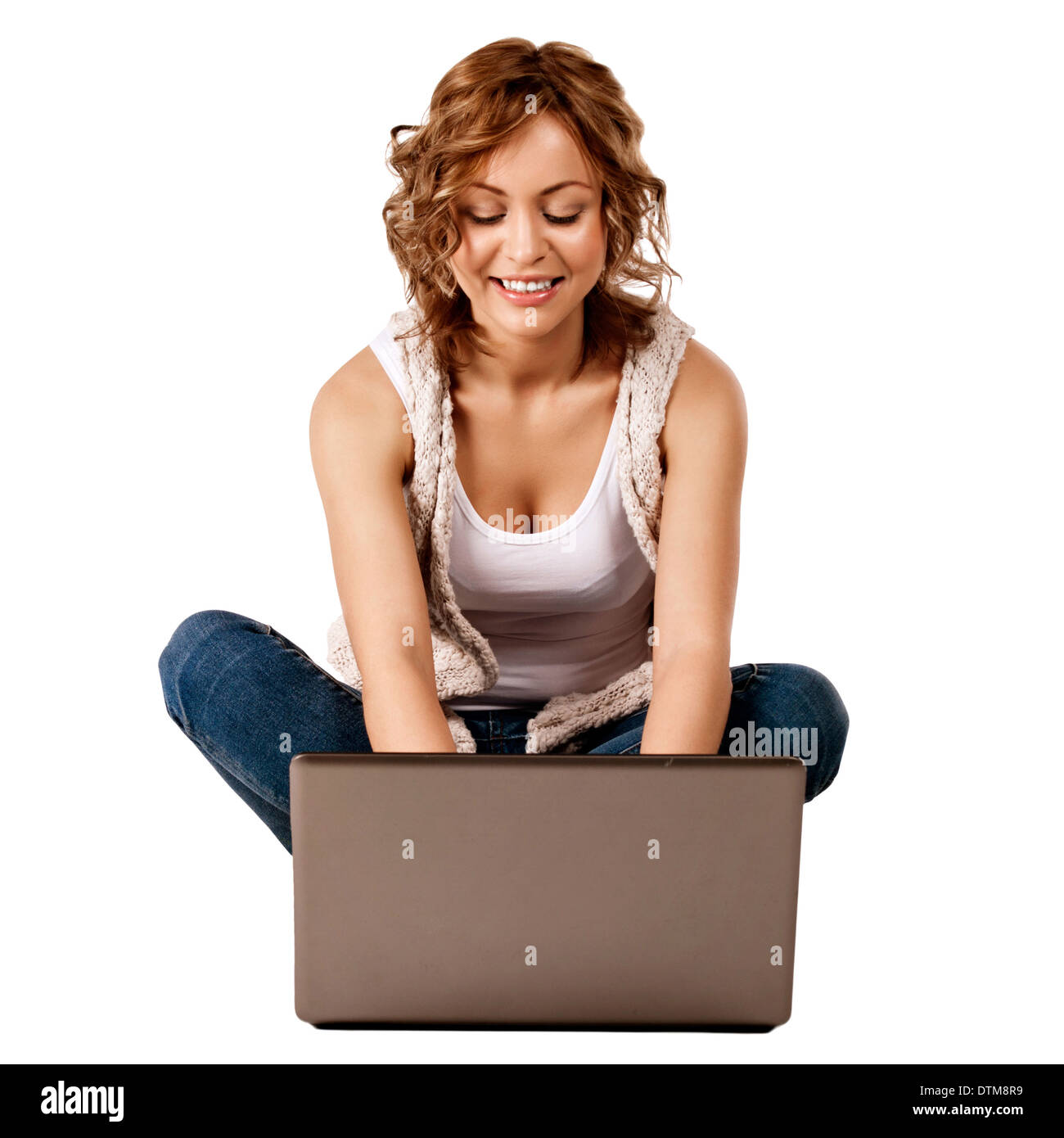 beautiful young girl sitting on the floor and using laptop Stock Photo