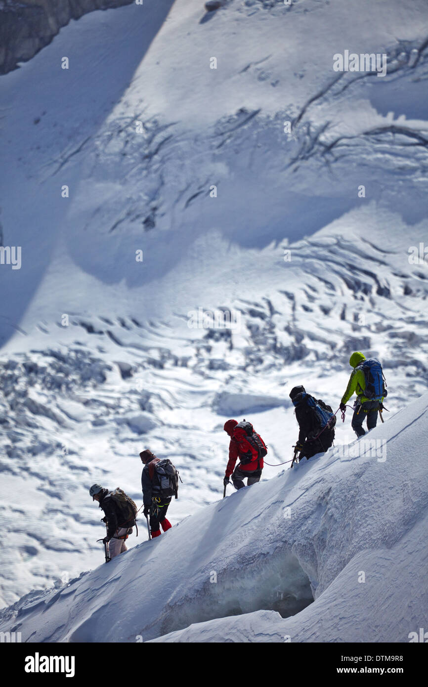 Climbers on a snowy ridge on Mont Blanc in the French Alps above Chamonix. Stock Photo