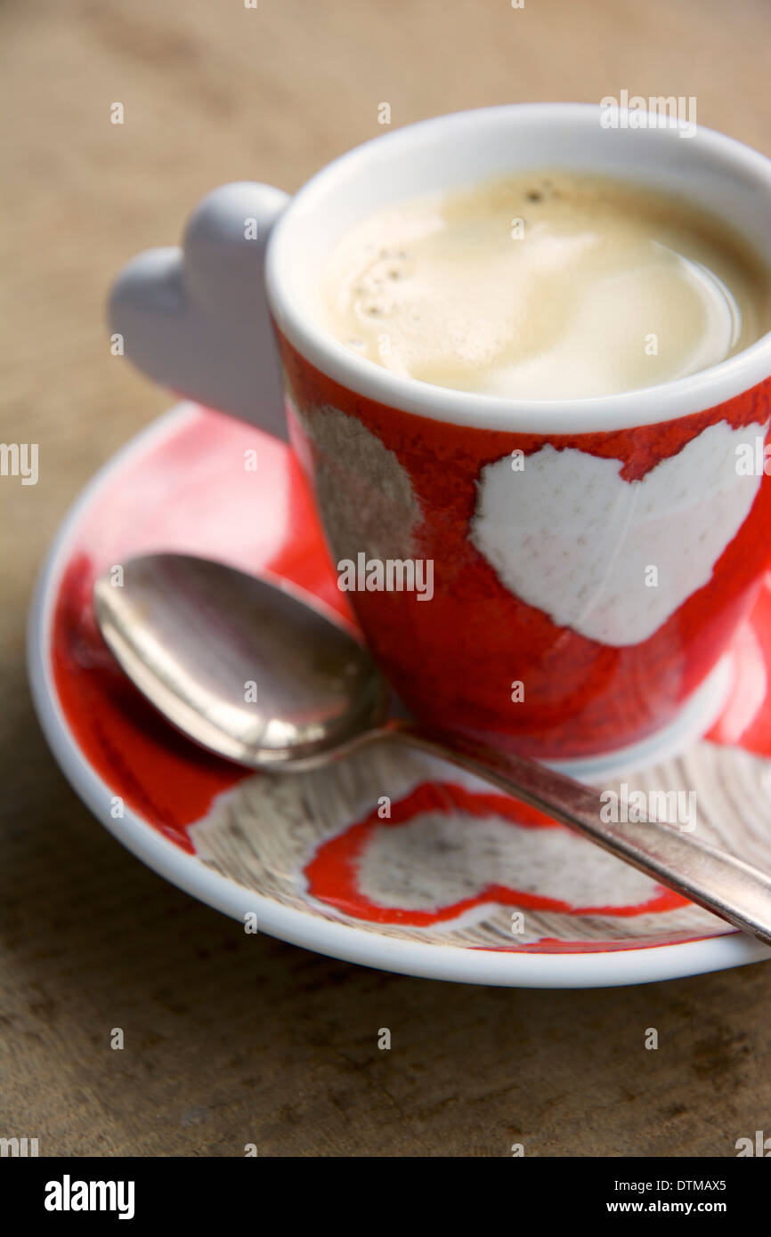 Small espresso cup with a heart decoration. Stock Photo