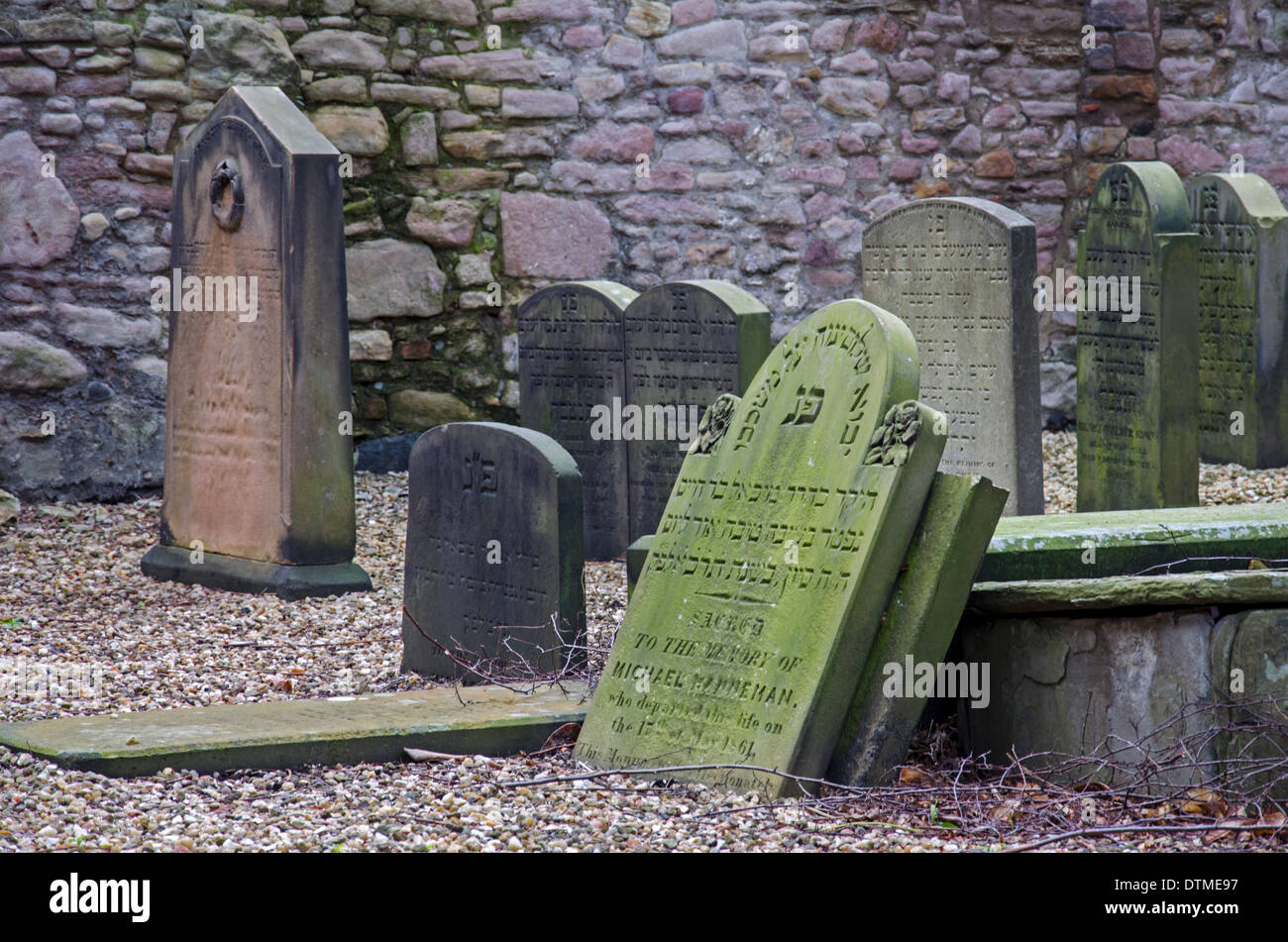 Worn and weathered Jewish headstones in what was the first Jewish Burial Ground in Scotland, opened in 1816. Stock Photo