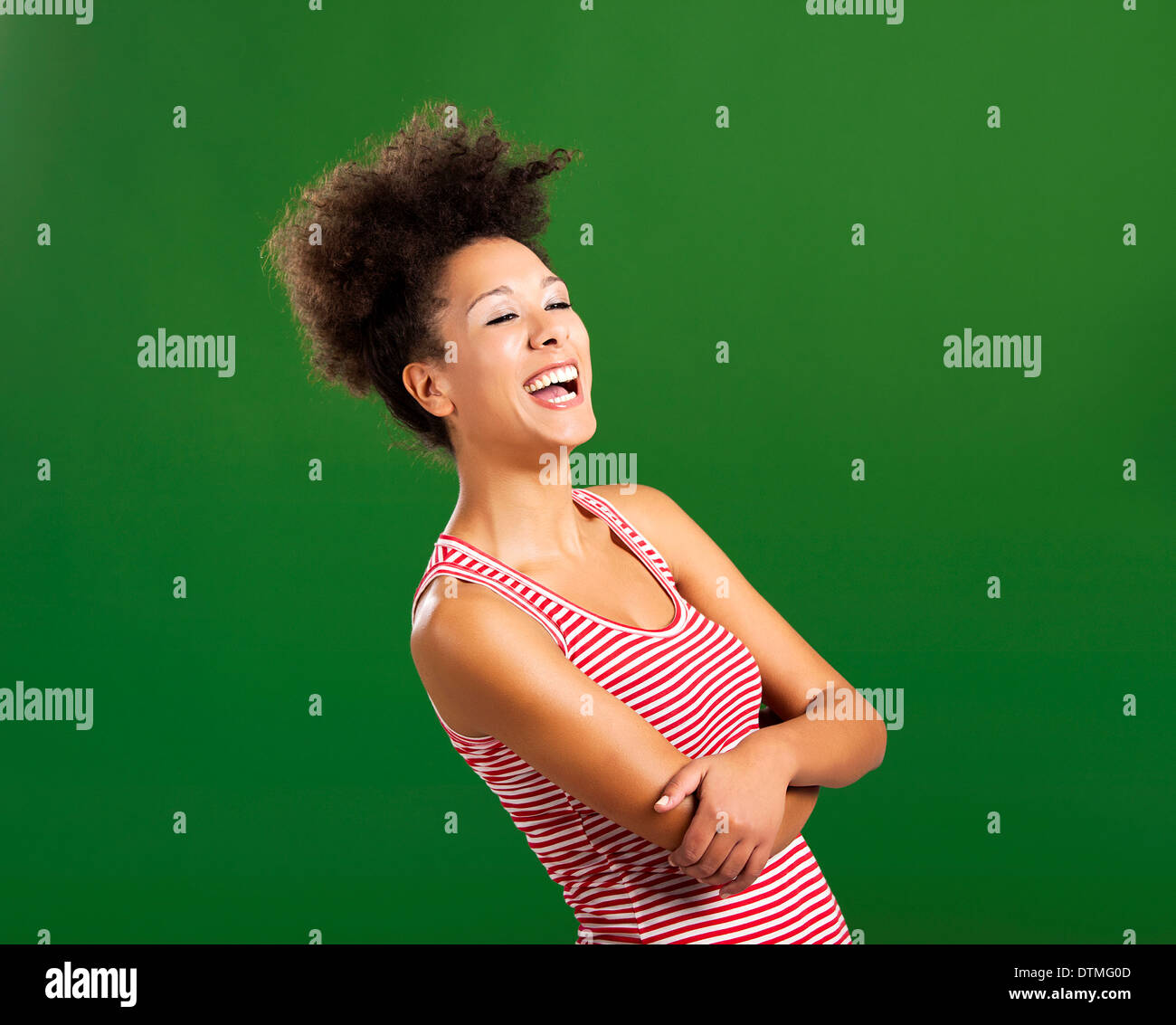 Beautiful African woman laughing over a green background Stock Photo ...