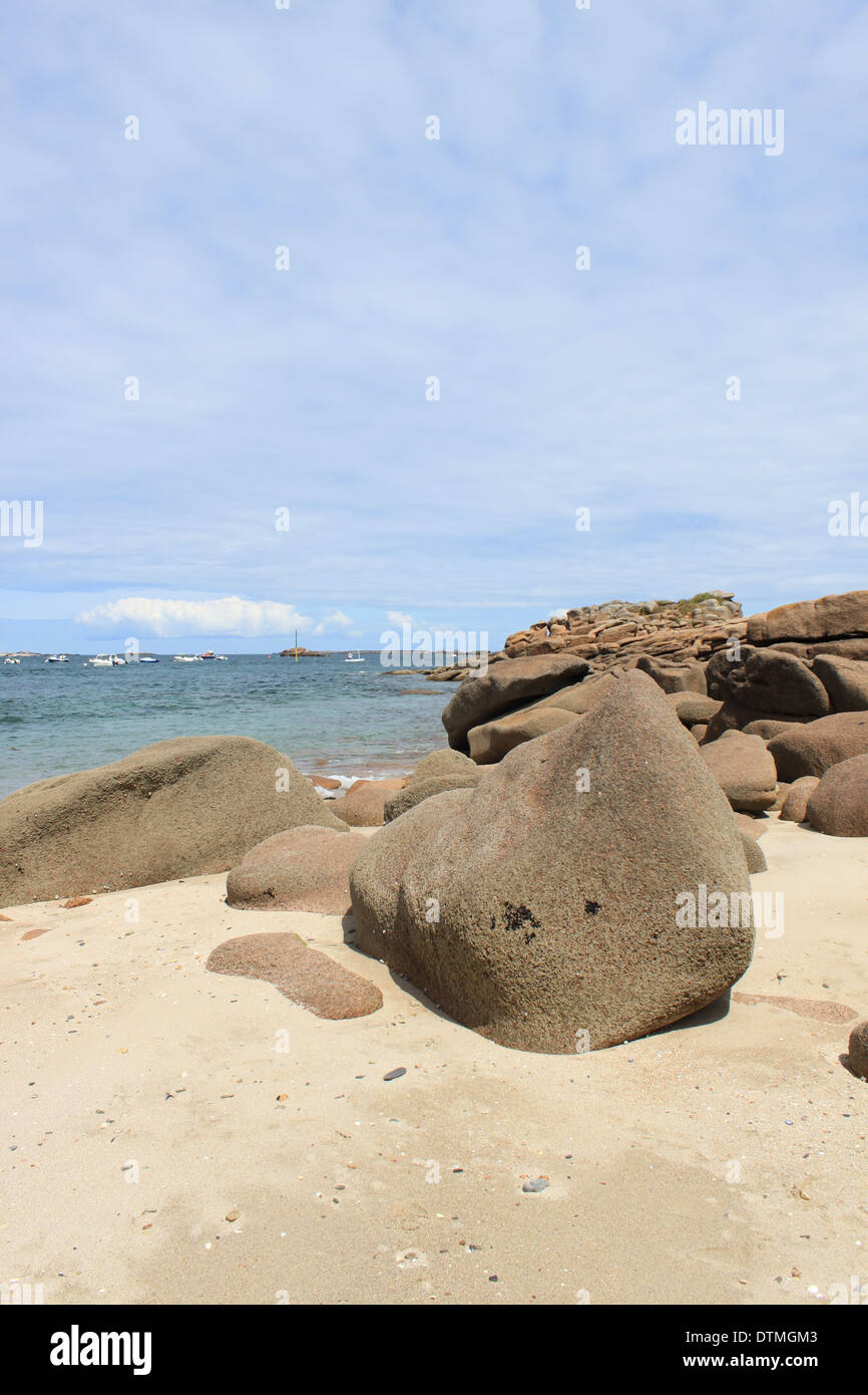 Round pink stone and ocean on a summer and sunny day Stock Photo