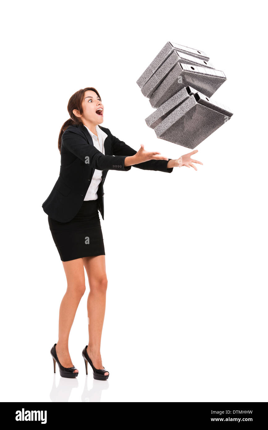 Beautiful business woman stumble while carrying lots of folders on hands, isolated over white background Stock Photo