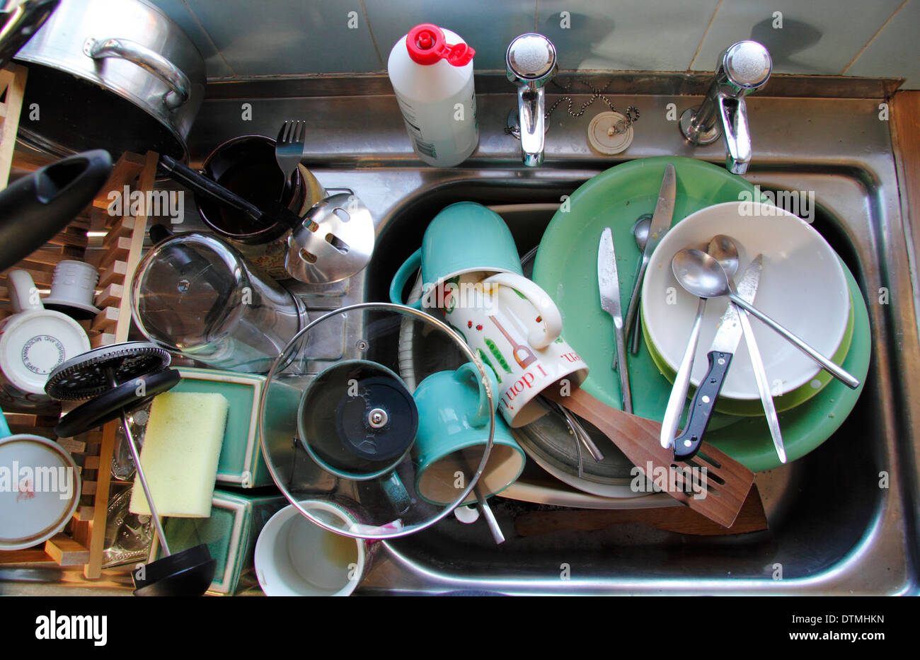 Kitchen sink stacked with dirty pots, England, UK Stock Photo