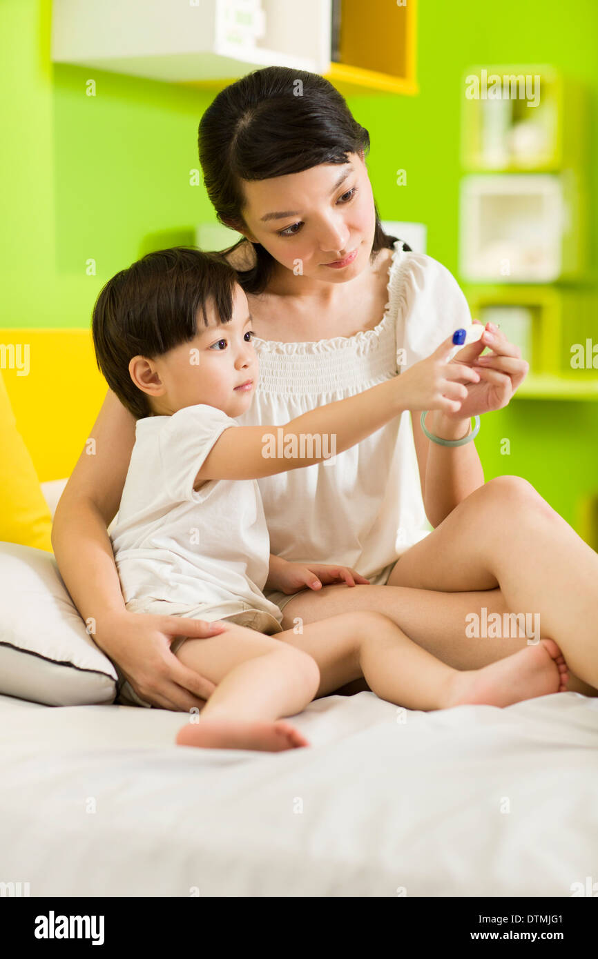 Mother taking sick daughter's temperature Stock Photo Alamy