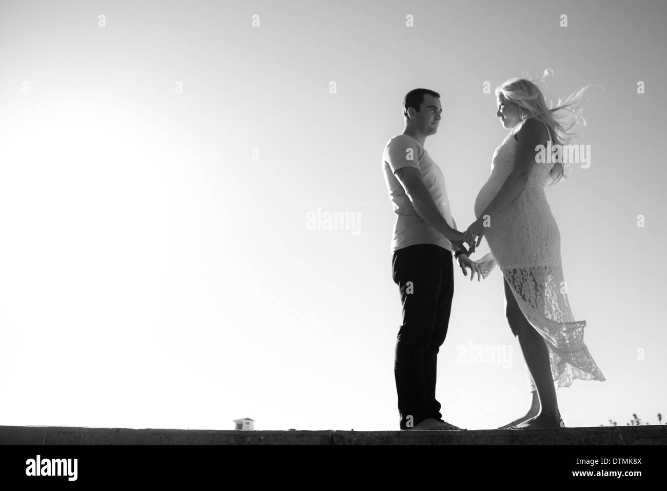 maternity shoot with a couple in love at the beach Stock Photo