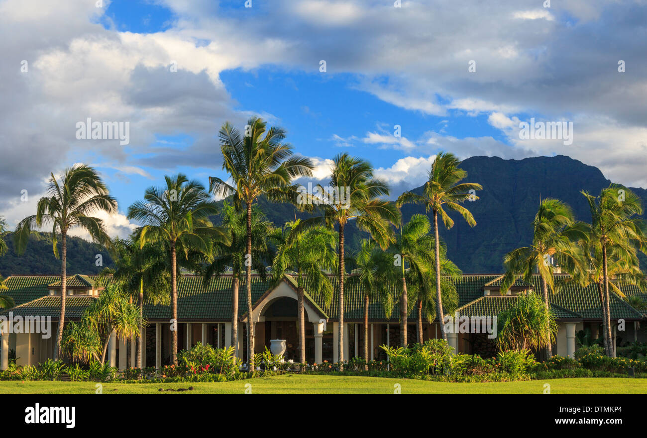 Entrance to the St. Regis Princeville Resort, with mountains with waterfall in distance Stock Photo