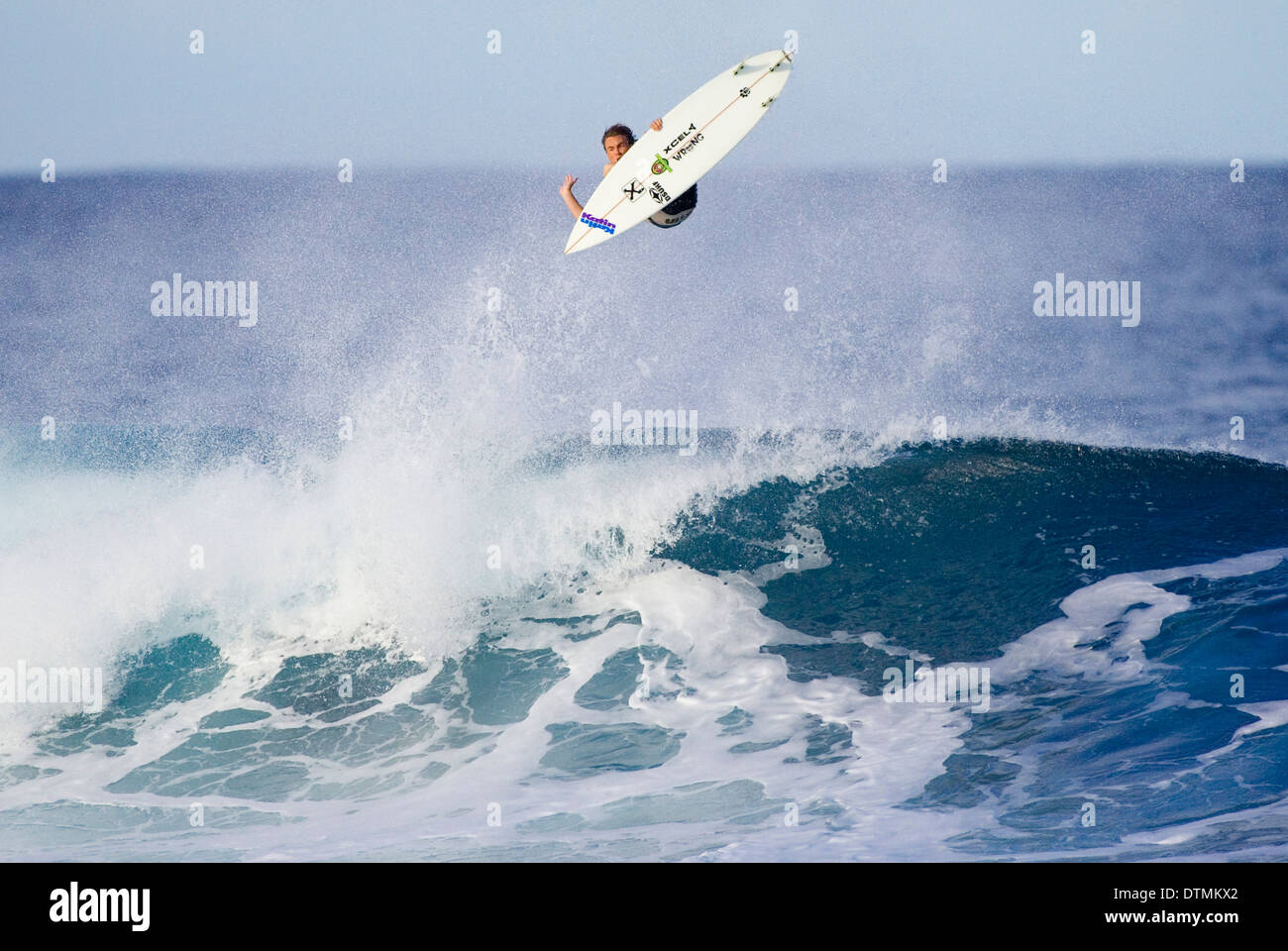 Ocean Wave Trick Roping surfer on a surfboard riding a wave in the ocean sea water wave beach ...