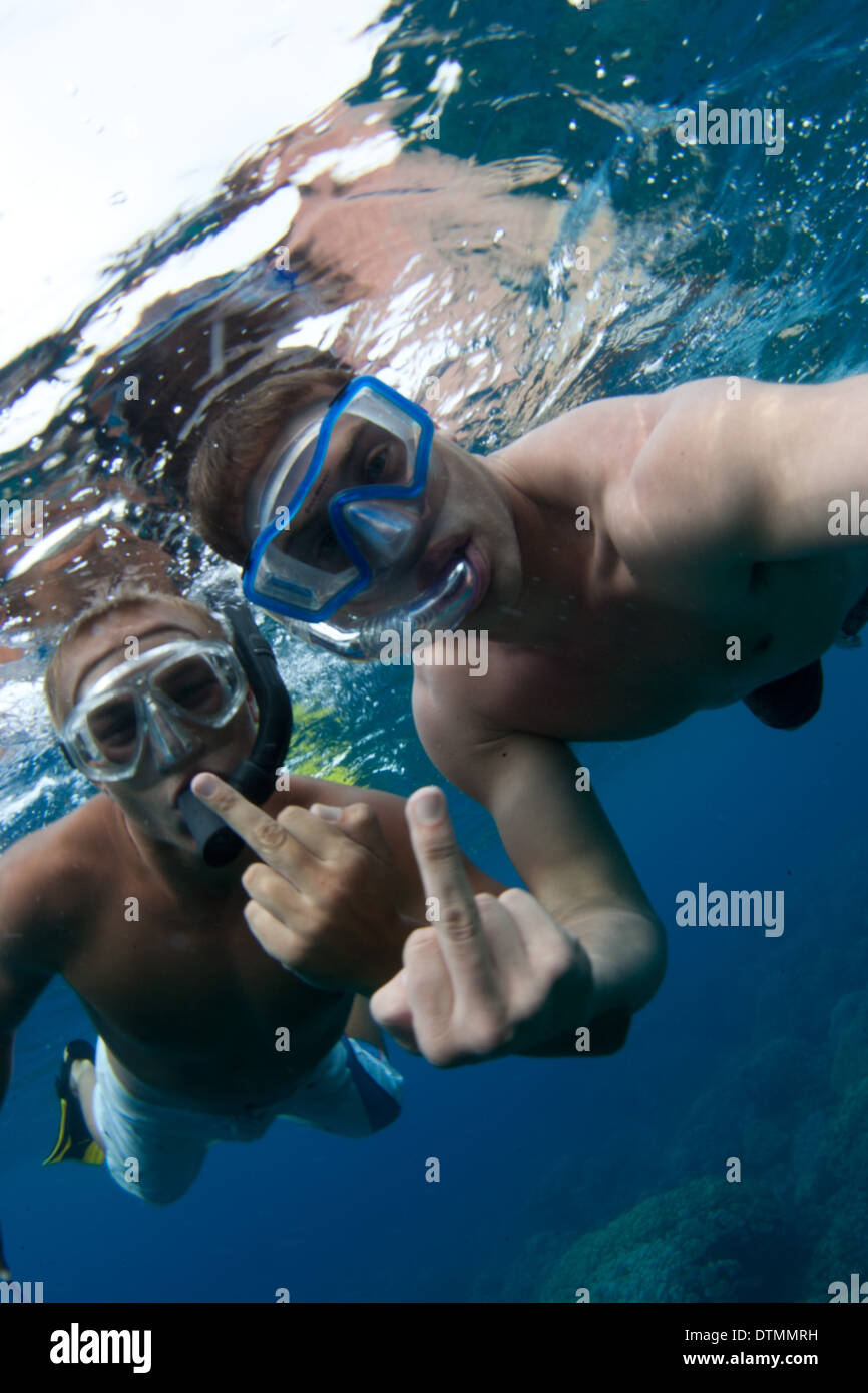 underwater flipping off the camera in hawaii with snorkel gear and