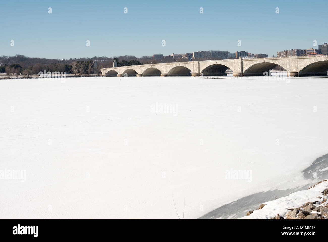 WASHINGTON DC, USA - Arlington Memorial Bridge spans an expanse of ice and snow-covered Potomac from Washington DC across to Arlington Virginia. The Potomac running through Washington DC is frozen and covered with a layer of snow. The region has experienced an unusually cold winter, with sustained low temperatures. Stock Photo