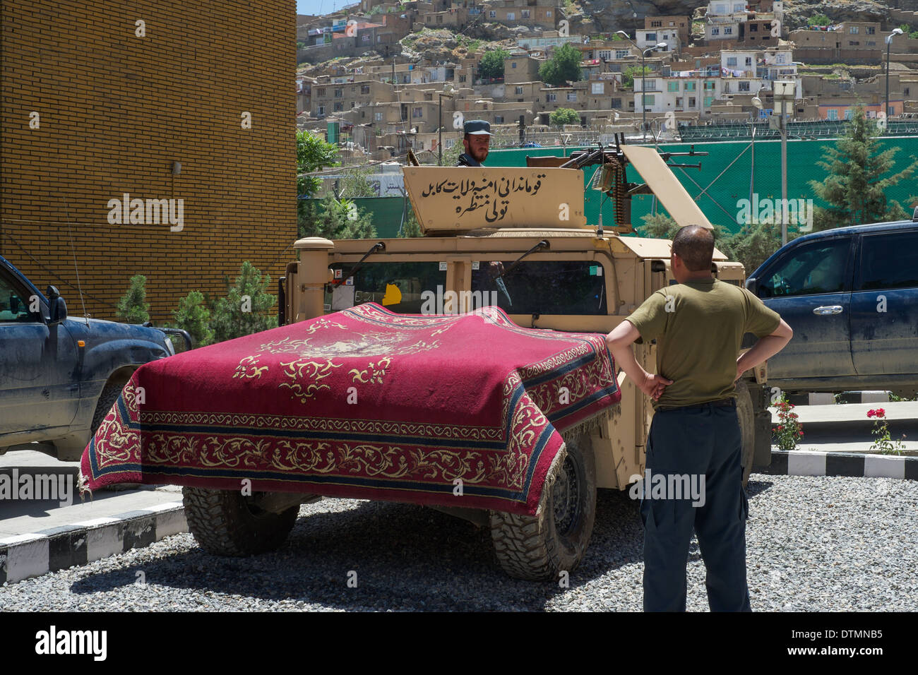 Afghan security forces drying a carpet in Kabul Stock Photo