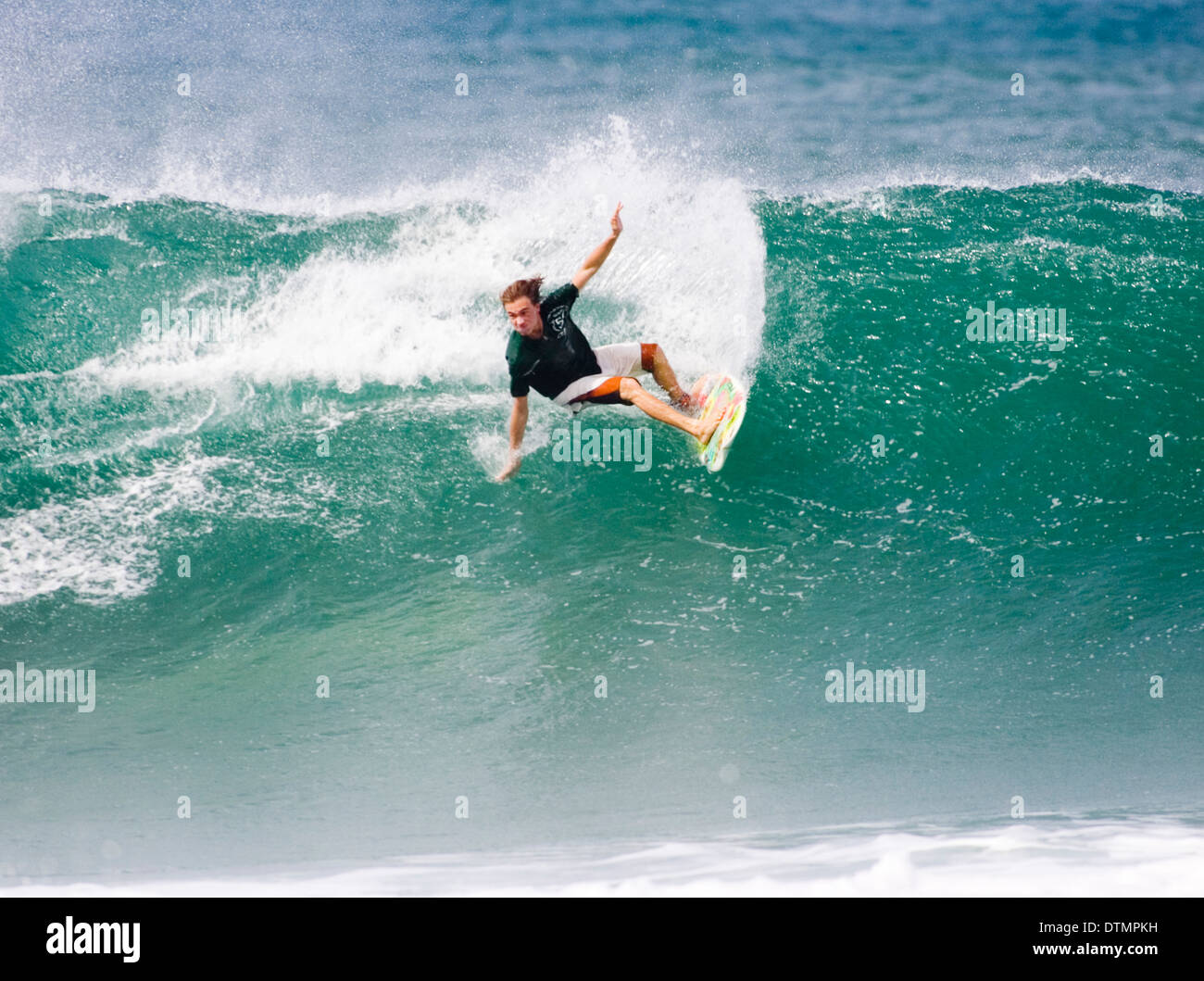 Large Waves With Surfer Surfing And Doing Tricks In The Large Waves With Surfer Surfing And Doing Tricks In The