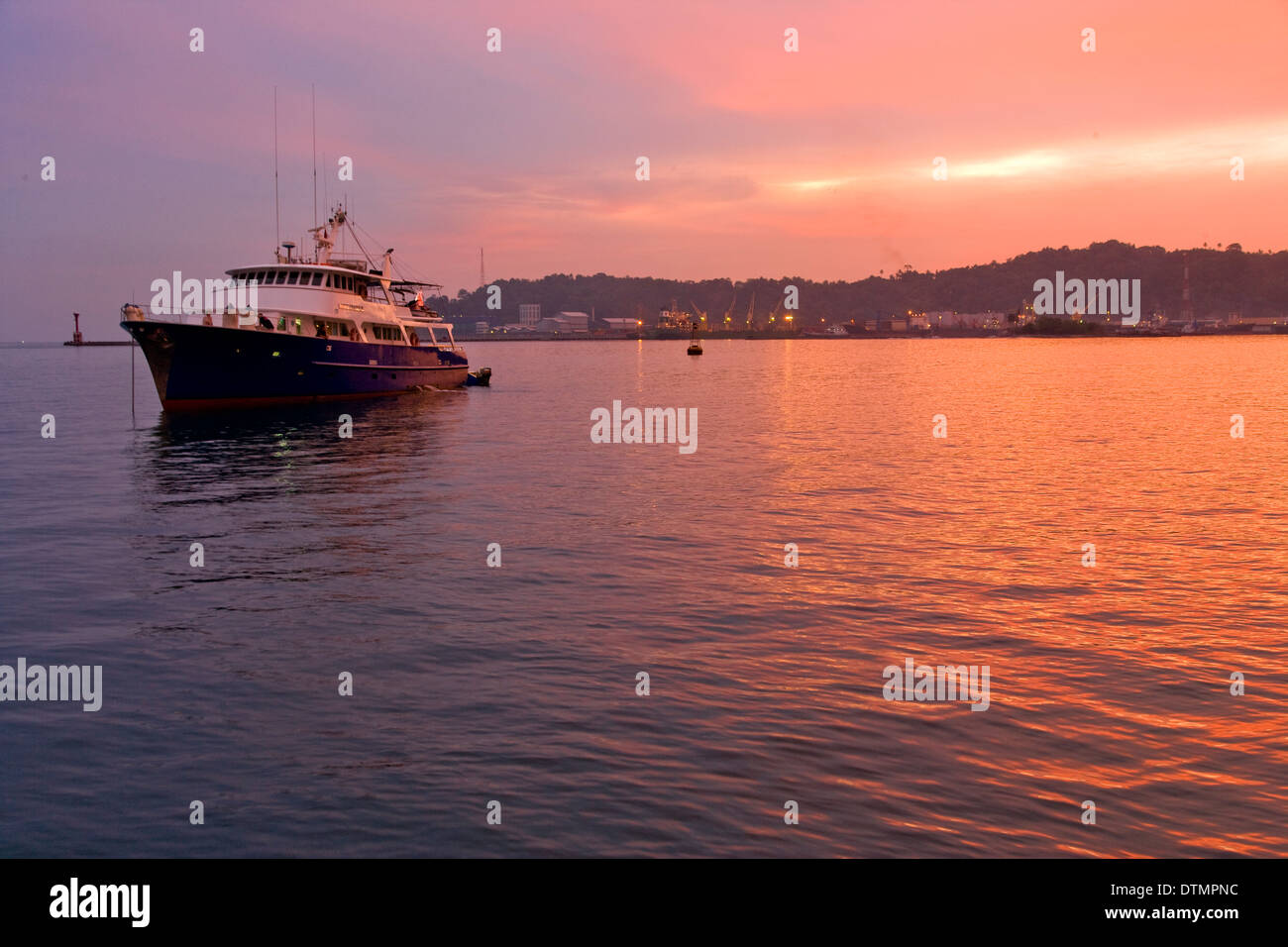 sunset image of a boat in the ocean sea water Stock Photo - Alamy
