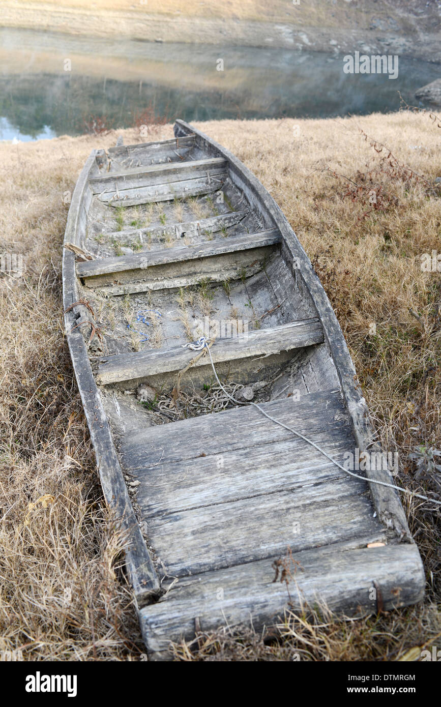 Broken boat at lakeside Stock Photo