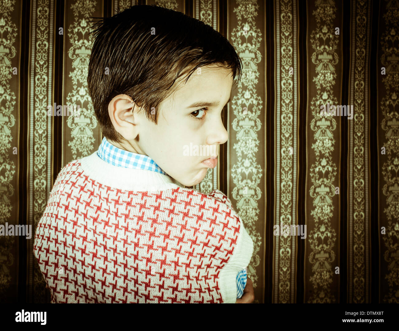Frowning child vintage clothes. Close up shot Stock Photo