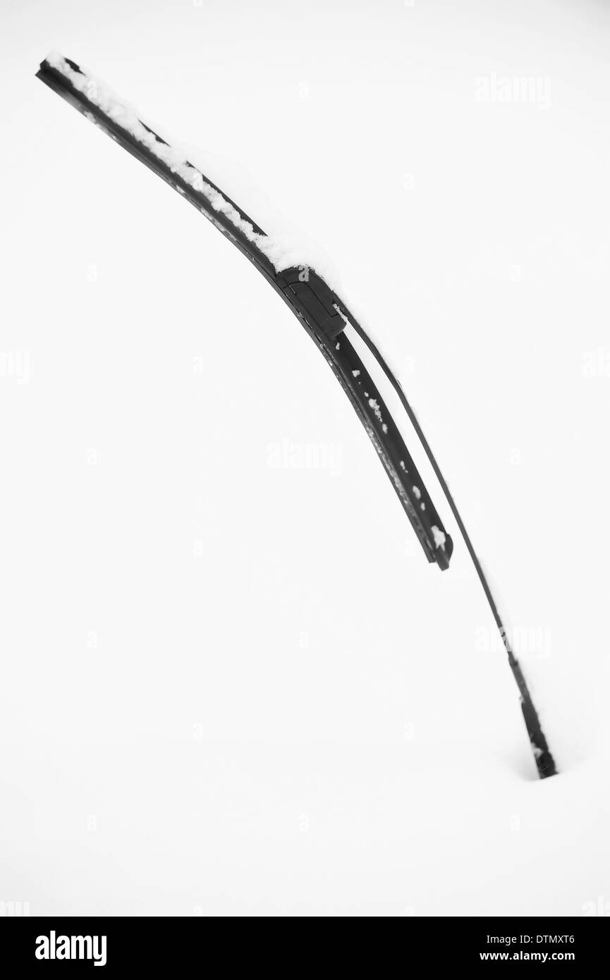 Windshield wiper from a snow covered car after heavy snowfall Stock Photo