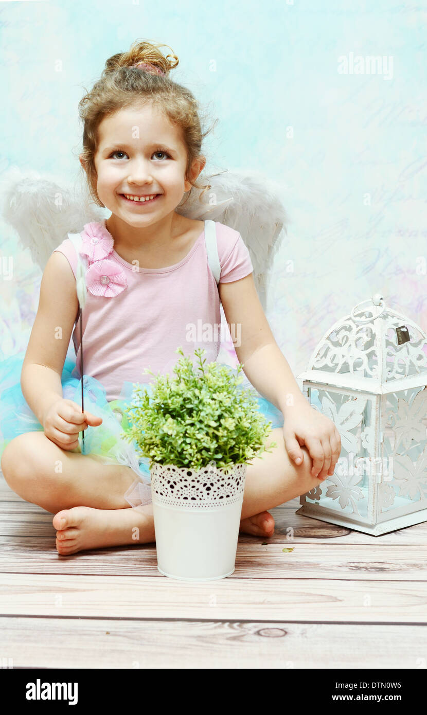 Little smiling witch with white wings Stock Photo