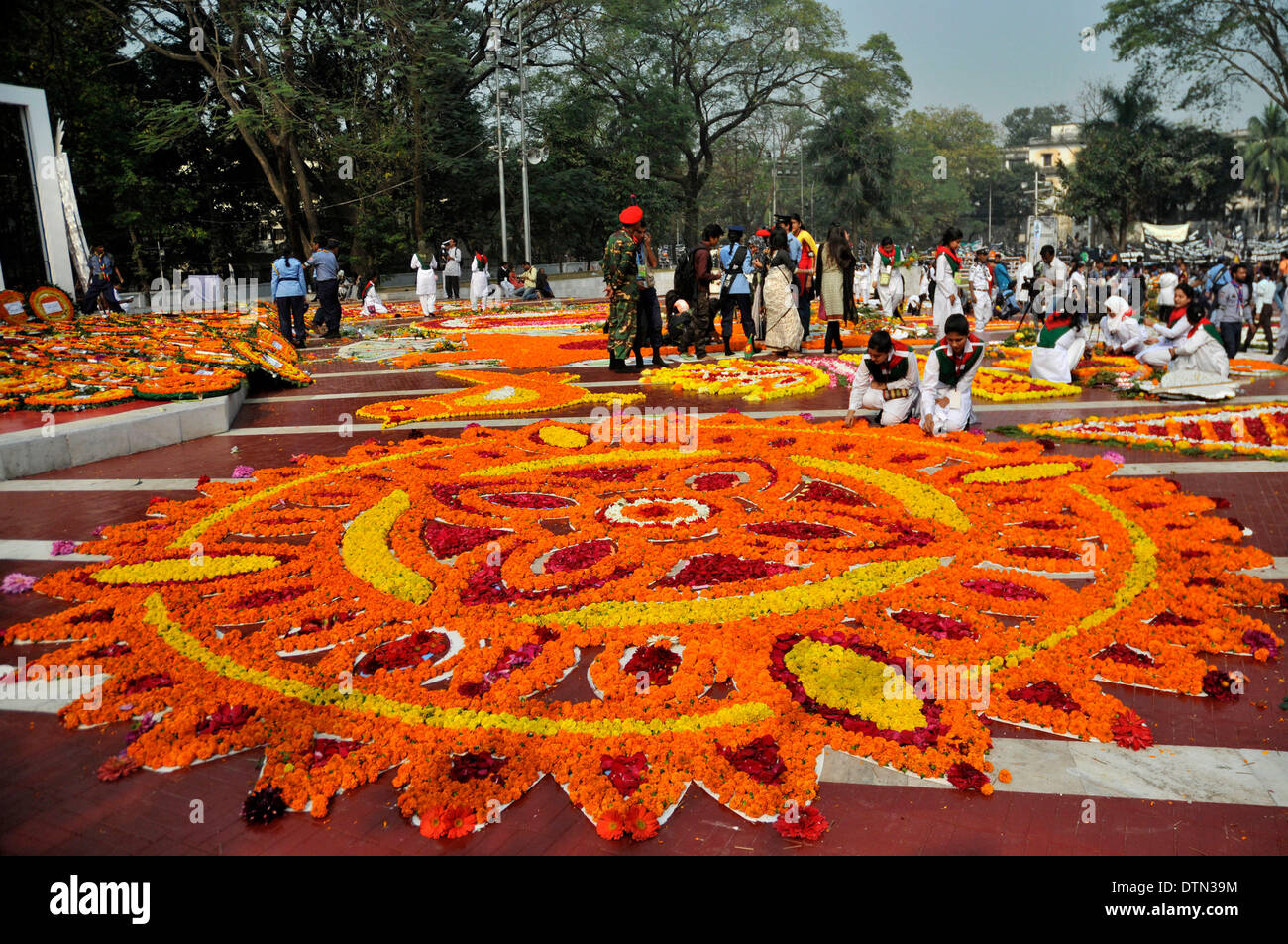 Dhaka, Bangladesh. 21st Feb 2014. Volunteers decorate Language Martyrs Memorial monument with flowers during the International Mother Language Day in Dhaka, Bangladesh, Feb. 21, 2014. People pay tributes every year to the language movement martyrs, who sacrificed their lives for establishing Bangla as a state language of then Pakistan in 1952. United Nations Educational, Scientific and Cultural Organization declared Feb. 21 the International Mother Language Day on Nov. 17, 1999 to honor the supreme sacrifice of language martyrs. (Xinhua Credit: © Xinhua/Alamy Live News  Stock Photo