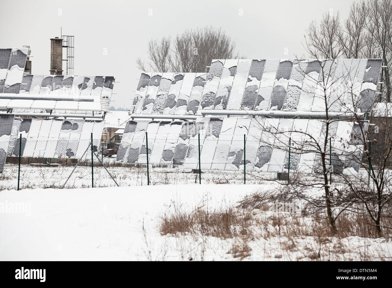 Photovoltaic solar panels covered by snow in winter. Stock Photo