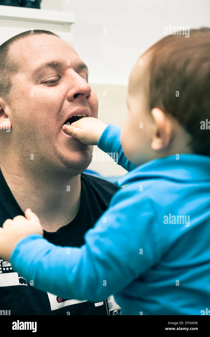 Closeup of baby boy playing with his daddy. Stock Photo