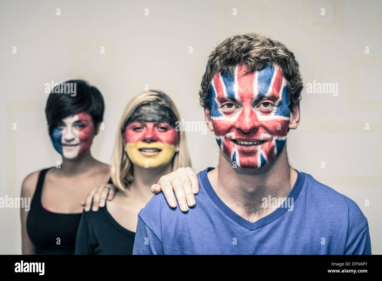 Group of happy people with painted European flags on their faces. Stock Photo