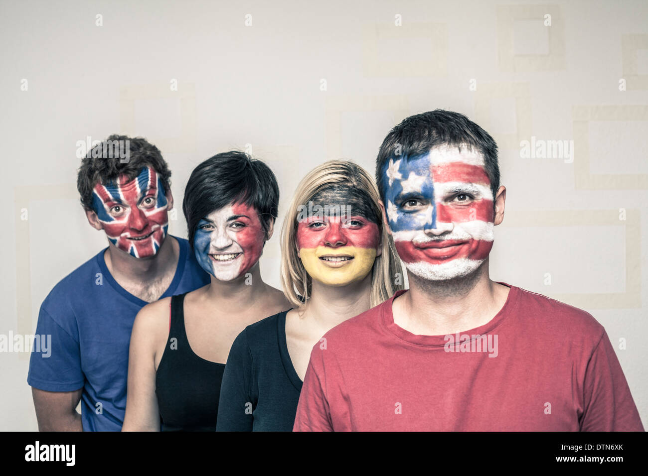 Group of happy people with painted flags on their faces. Stock Photo