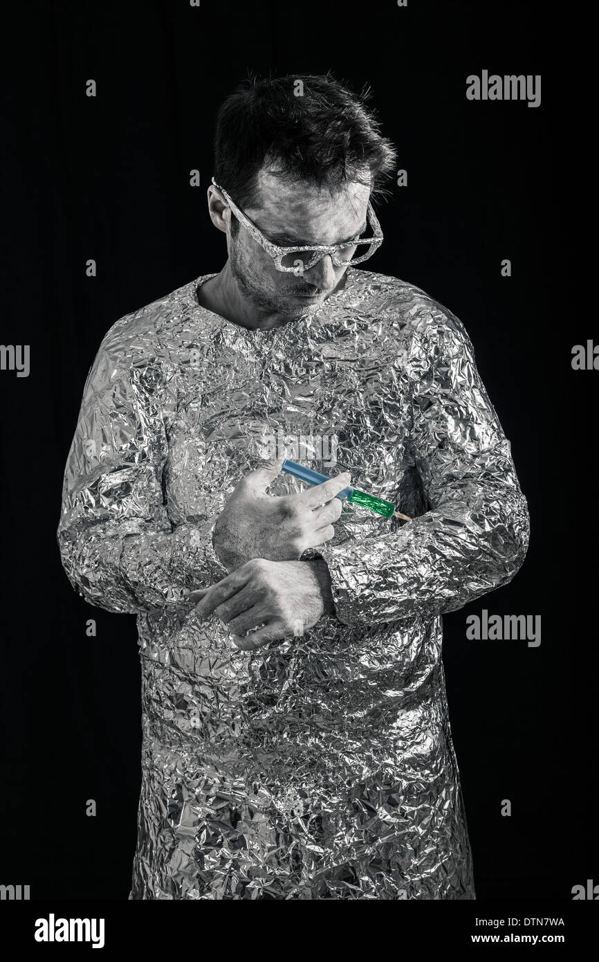 Portrait of spaceman applying syringe. Stock Photo