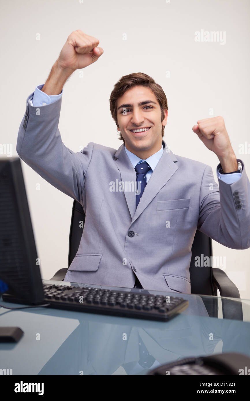 Businessman raising his fists in success Stock Photo - Alamy
