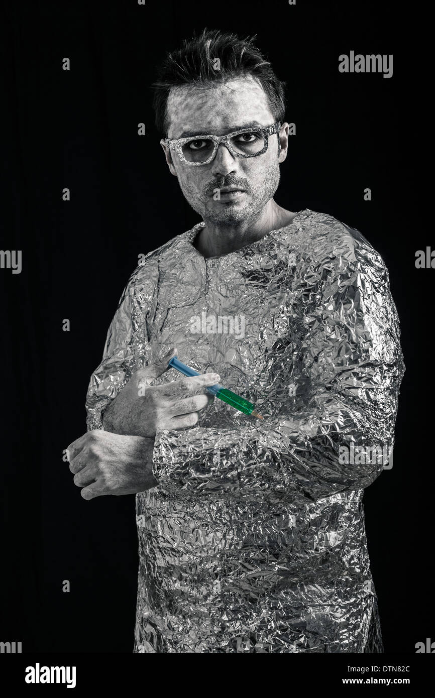 Portrait of spaceman applying syringe. Stock Photo