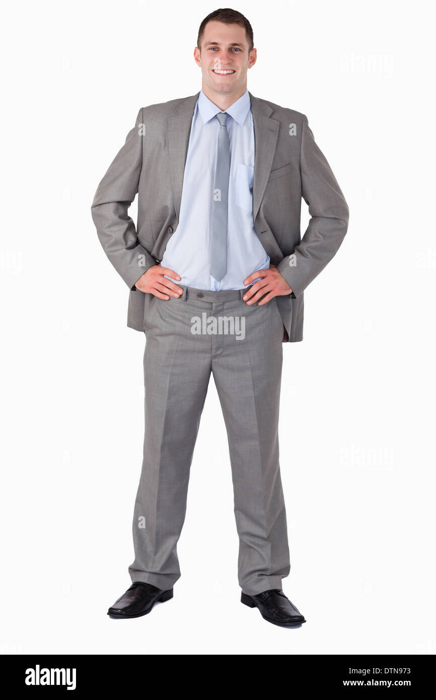 Smiling businessman with arms akimbo Stock Photo