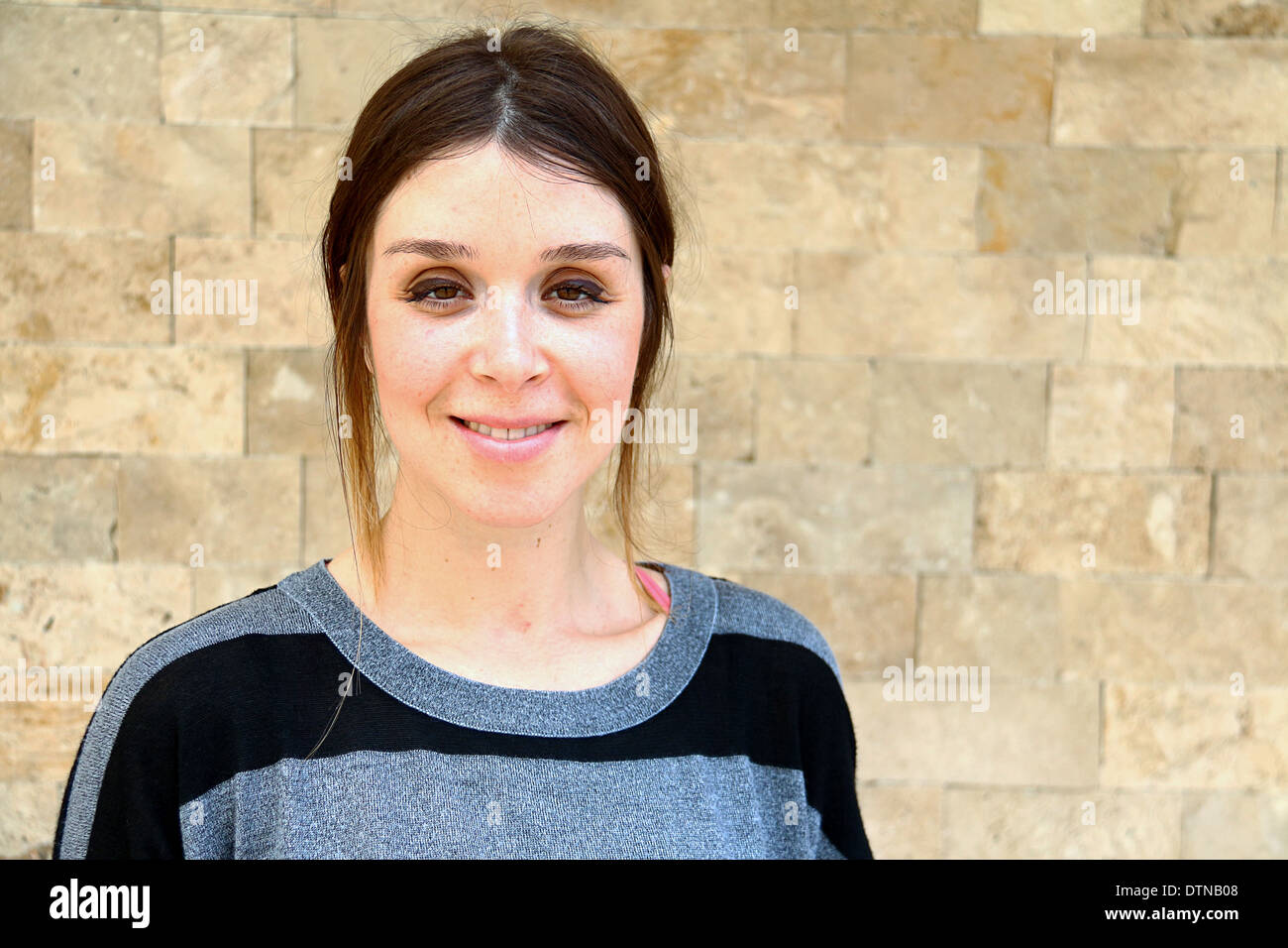 Young Turkish Women Portrait With Stone Wall Background Stock Photo