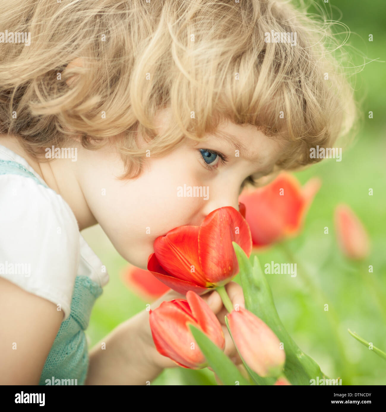 Child smelling flower hi-res stock photography and images - Alamy