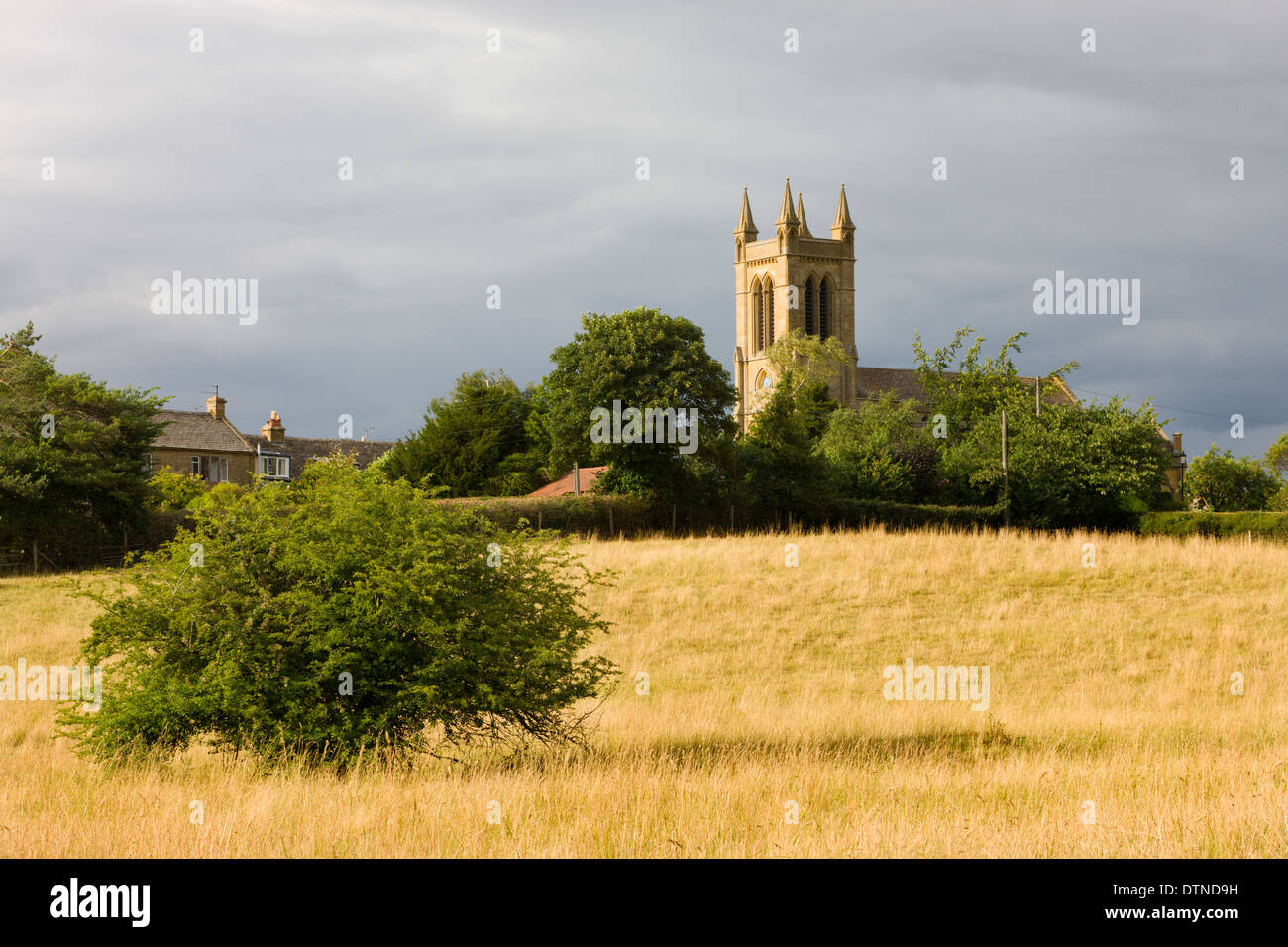 Rural field with views to St Michaels Church in the Cotswolds village of Broadway, Worcestershire, England. Summer (July) 2010. Stock Photo