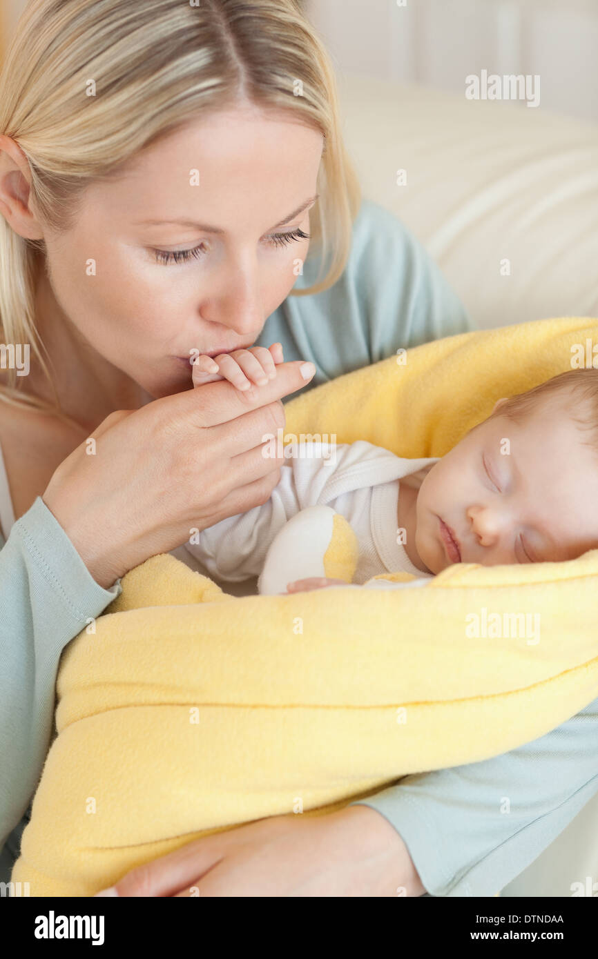 Close up of mother kissing her baby's hand Stock Photo - Alamy, image size:866x1390