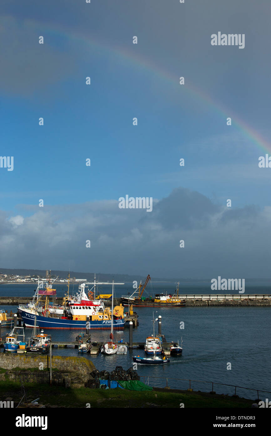 A rainbow over Newlyn harbour, Cornwall, UK. Stock Photo