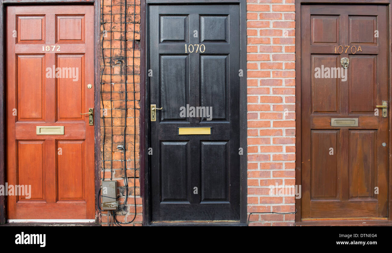 Three front doors on a row of flats and houses in Manchester, England, UK Stock Photo