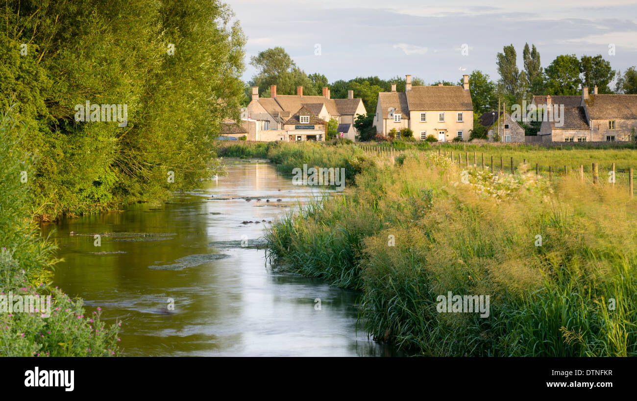 Cottages near the River Coln at Fairford in the Cotswolds, Gloucestershire, England. Summer (July) 2010. Stock Photo