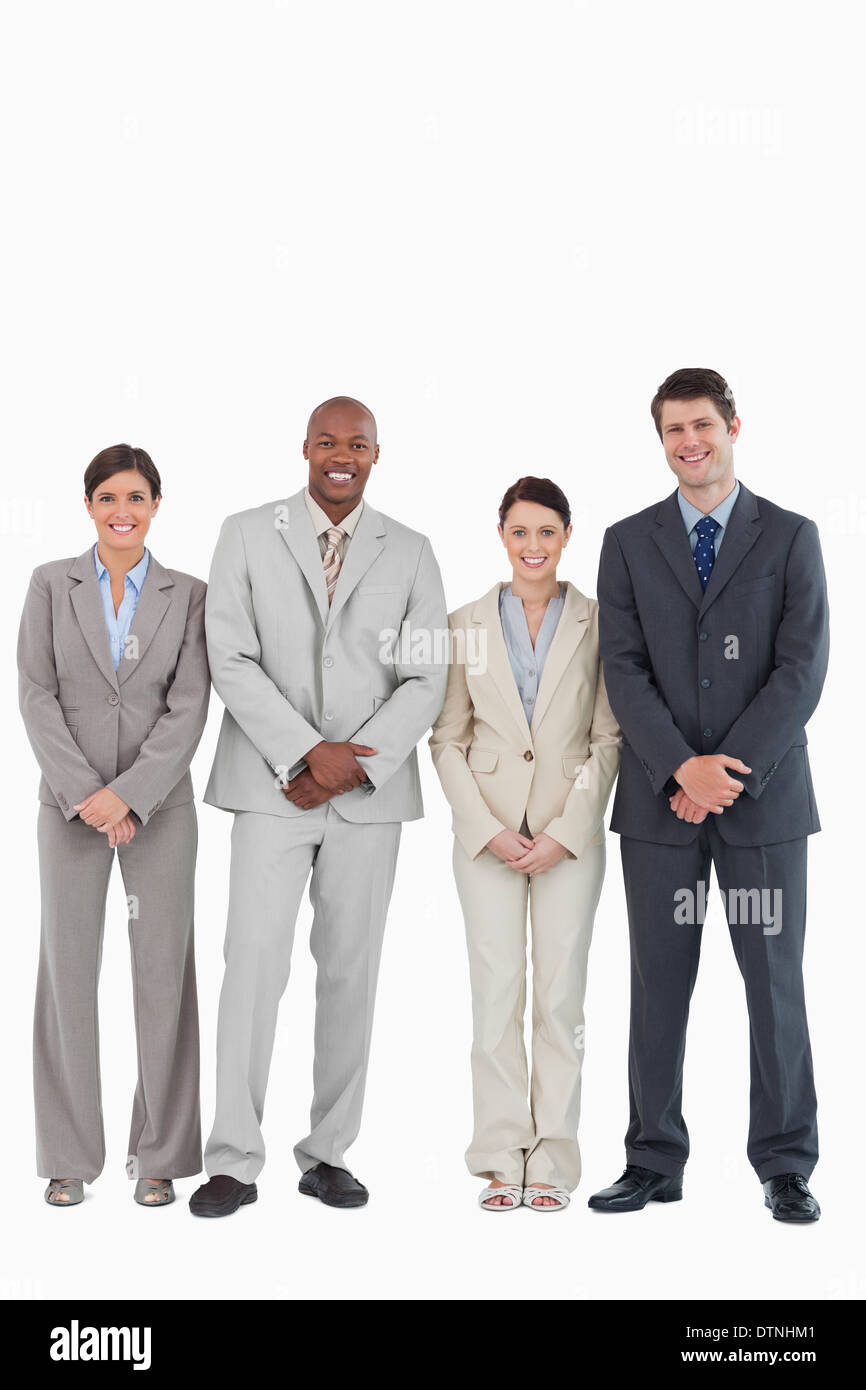 Smiling young businessteam standing together Stock Photo - Alamy