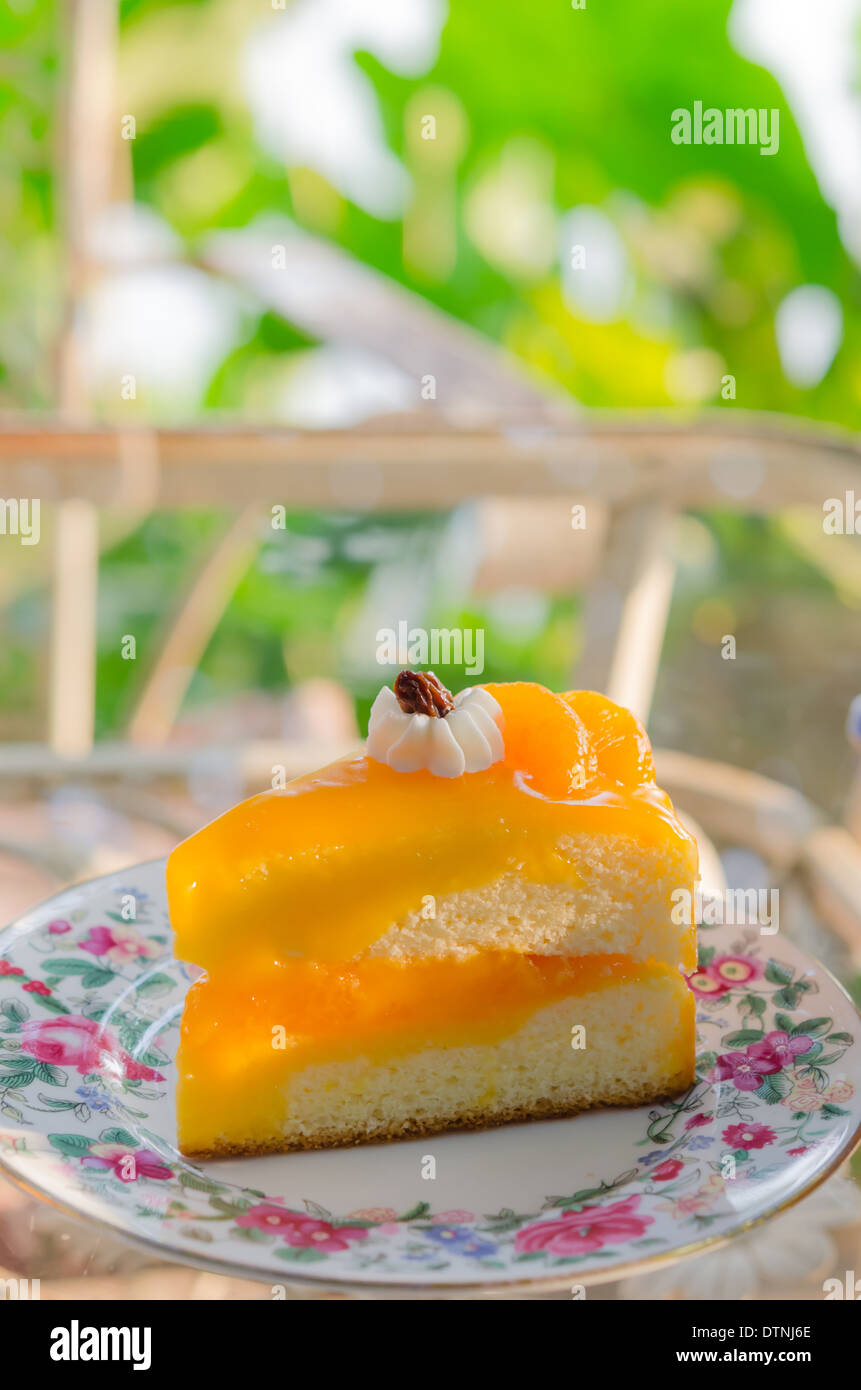 piece of fresh orange cake on dish Stock Photo