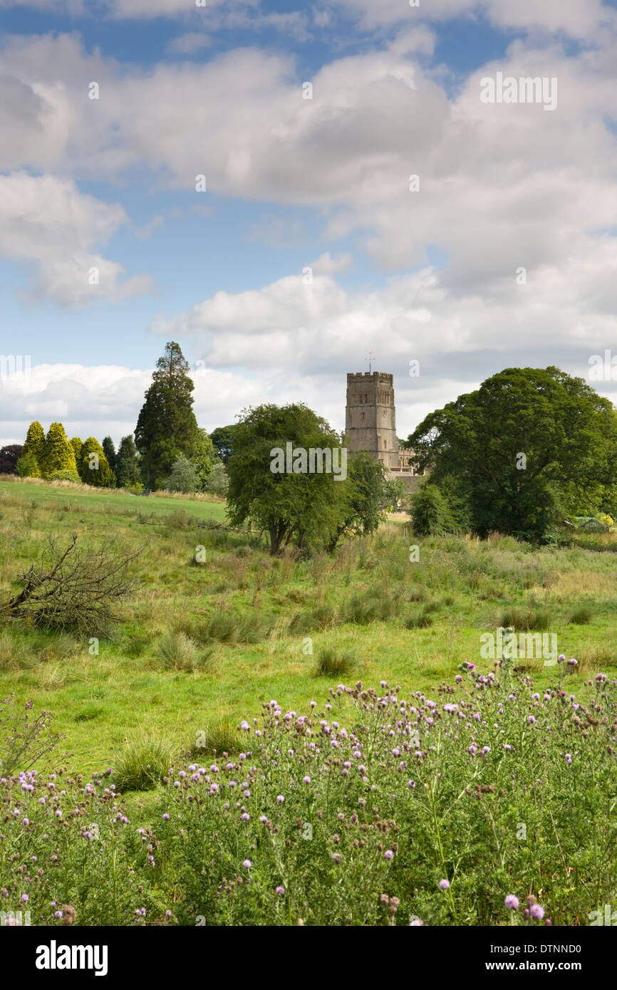 Northleach Church from across a meadow in the picturesque Cotswolds, Gloucestershire, England. Summer (July) 2010. Stock Photo